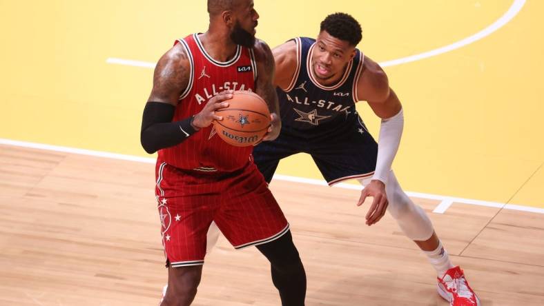 Feb 18, 2024; Indianapolis, Indiana, USA; Eastern Conference forward Giannis Antetokounmpo (34) of the Milwaukee Bucks defends Western Conference forward LeBron James (23) of the Los Angeles Lakers during the first quarter in the 73rd NBA All Star game at Gainbridge Fieldhouse. Mandatory Credit: Trevor Ruszkowski-USA TODAY Sports