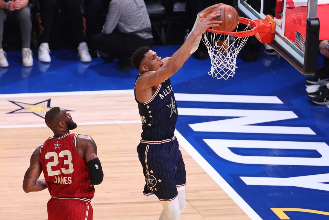 Feb 18, 2024; Indianapolis, Indiana, USA; Eastern Conference forward Giannis Antetokounmpo (34) of the Milwaukee Bucks dunks the ball past Western Conference forward LeBron James (23) of the Los Angeles Lakers during the first quarter in the 73rd NBA All Star game at Gainbridge Fieldhouse. Mandatory Credit: Trevor Ruszkowski-USA TODAY Sports