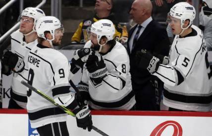 Feb 18, 2024; Pittsburgh, Pennsylvania, USA;  Los Angeles Kings right wing Adrian Kempe (9) celebrates with the Kings bench after scoring the game winning goal against the Pittsburgh Penguins during the third period at PPG Paints Arena. Los Angeles won 2-1. Mandatory Credit: Charles LeClaire-USA TODAY Sports