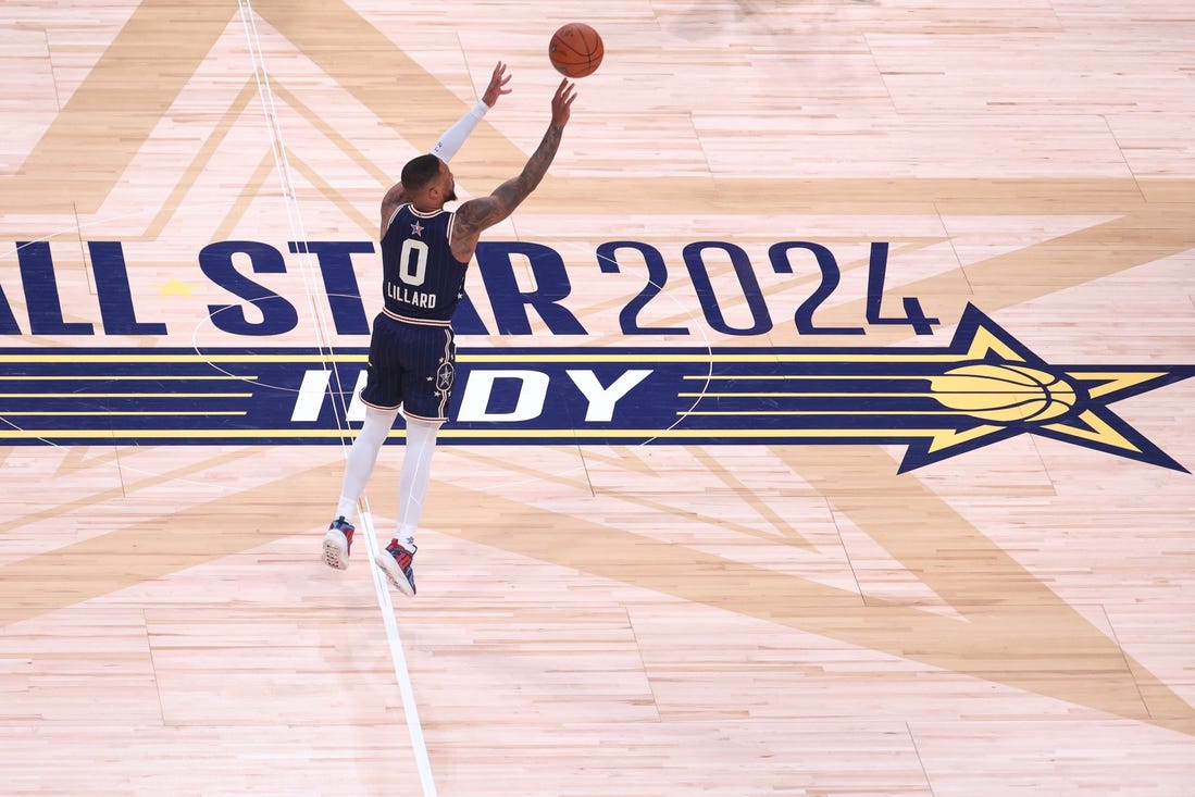 Feb 18, 2024; Indianapolis, Indiana, USA; Eastern Conference guard Damian Lillard (0) of the Milwaukee Bucks makes a three point basket from half court against the Western Conference All-Stars during the fourth quarter in the 73rd NBA All Star game at Gainbridge Fieldhouse. Mandatory Credit: Trevor Ruszkowski-USA TODAY Sports