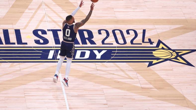 Feb 18, 2024; Indianapolis, Indiana, USA; Eastern Conference guard Damian Lillard (0) of the Milwaukee Bucks makes a three point basket from half court against the Western Conference All-Stars during the fourth quarter in the 73rd NBA All Star game at Gainbridge Fieldhouse. Mandatory Credit: Trevor Ruszkowski-USA TODAY Sports