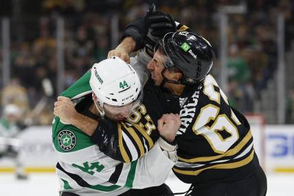 Feb 19, 2024; Boston, Massachusetts, USA; Dallas Stars defenseman Joel Hanley (44) fights with Boston Bruins left wing Brad Marchand (63) during the first period at TD Garden. Mandatory Credit: Winslow Townson-USA TODAY Sports