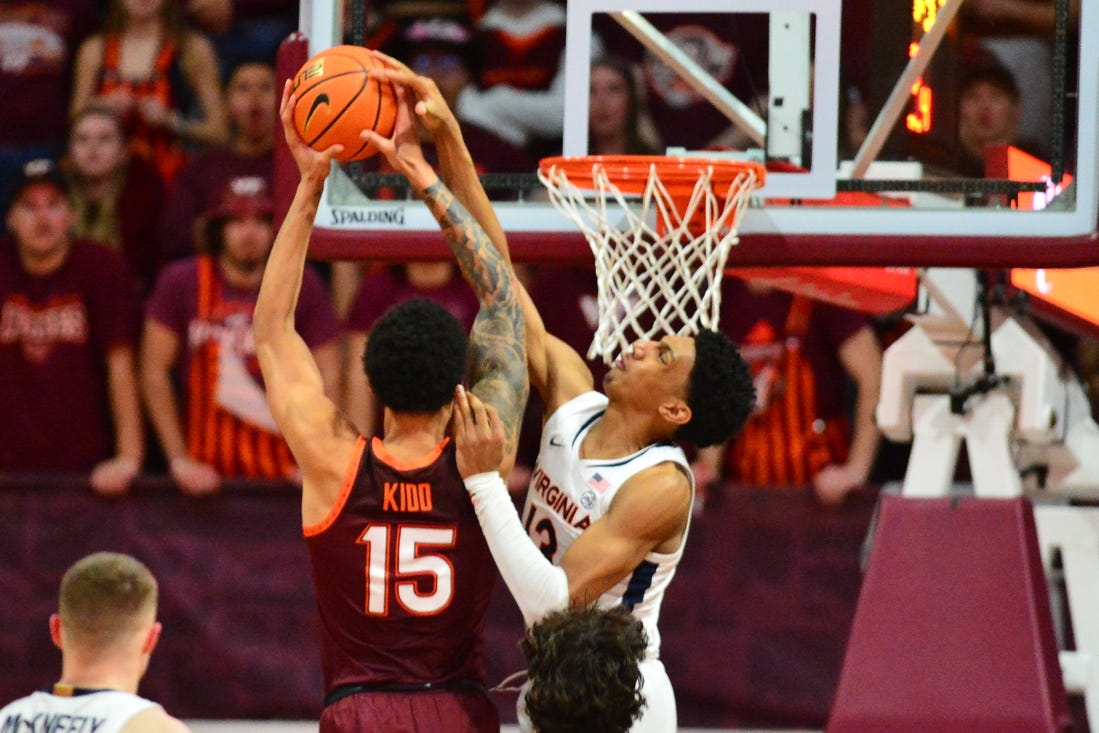 Feb 19, 2024; Blacksburg, Virginia, USA; Virginia Cavaliers guard Ryan Dunn (13) goes up to defend a dunk by Virginia Tech Hokies center Lynn Kidd (15) during the first half at Cassell Coliseum. Mandatory Credit: Brian Bishop-USA TODAY Sports