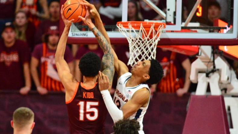 Feb 19, 2024; Blacksburg, Virginia, USA; Virginia Cavaliers guard Ryan Dunn (13) goes up to defend a dunk by Virginia Tech Hokies center Lynn Kidd (15) during the first half at Cassell Coliseum. Mandatory Credit: Brian Bishop-USA TODAY Sports