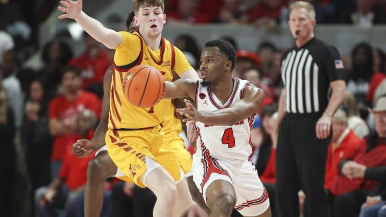 Feb 19, 2024; Houston, Texas, USA; Houston Cougars guard L.J. Cryer (4) passes the ball during the first half against the Iowa State Cyclones at Fertitta Center. Mandatory Credit: Troy Taormina-USA TODAY Sports