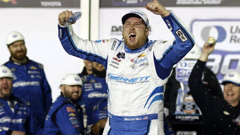 Feb 19, 2024; Daytona Beach, Florida, USA;  Xfinity Series driver Austin Hill (21) reacts in victory lane after winning the United Rentals 300 at Daytona International Speedway. Mandatory Credit: Peter Casey-USA TODAY Sports