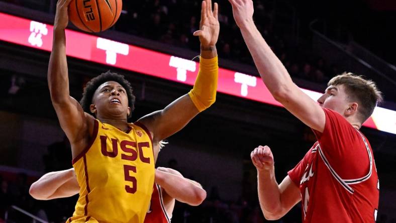 Feb 15, 2024; Los Angeles, California, USA; Southern California Trojans guard Boogie Ellis (5) shoots against Utah Utes center Lawson Lovering (right) during the second half at Galen Center. Mandatory Credit: Alex Gallardo-USA TODAY Sports