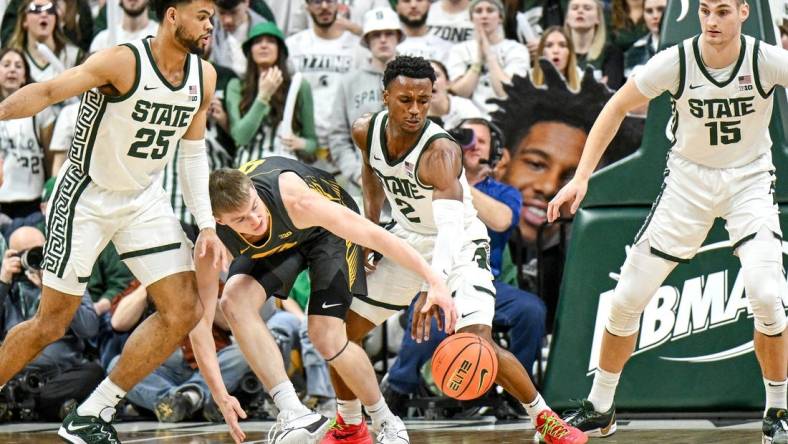 Michigan State's Tyson Walker, right, steals the ball from Iowa's Josh Dix during the first half on Tuesday, Feb. 20, 2024, at the Breslin Center in East Lansing.