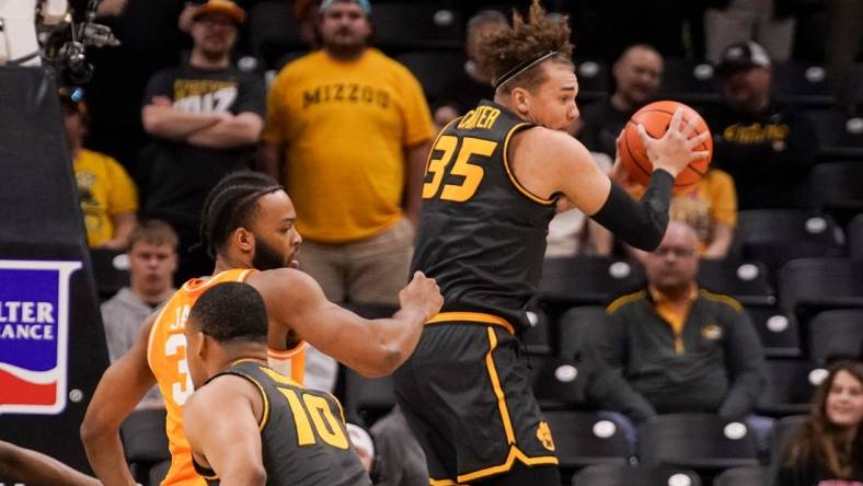 Feb 20, 2024; Columbia, Missouri, USA; Missouri Tigers forward Noah Carter (35) rebounds as Tennessee Volunteers guard Dalton Knecht (3) defends during the first half at Mizzou Arena. Mandatory Credit: Denny Medley-USA TODAY Sports