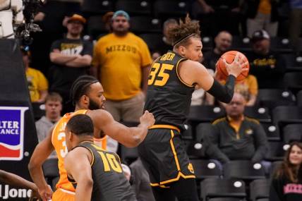Feb 20, 2024; Columbia, Missouri, USA; Missouri Tigers forward Noah Carter (35) rebounds as Tennessee Volunteers guard Dalton Knecht (3) defends during the first half at Mizzou Arena. Mandatory Credit: Denny Medley-USA TODAY Sports