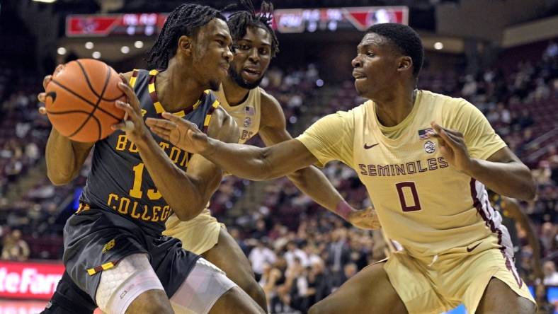 Feb 20, 2024; Tallahassee, Florida, USA; Boston College Eagles guard Donald Hand Jr. (13) is pressured by Florida State Seminoles guard Chandler Jackson (0) during the first half at Donald L. Tucker Center. Mandatory Credit: Melina Myers-USA TODAY Sports