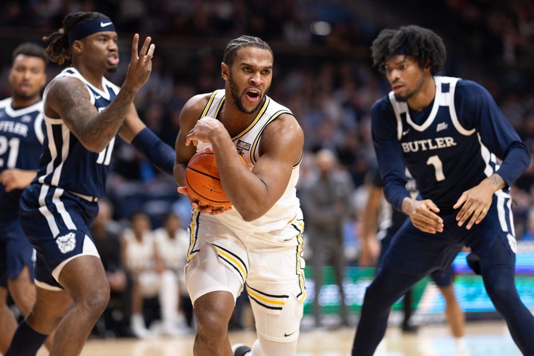 Feb 20, 2024; Villanova, Pennsylvania, USA; Villanova Wildcats forward Eric Dixon (43) controls the ball against Butler Bulldogs guard Jahmyl Telfort (11) and forward Jalen Thomas (1) during the second half at William B. Finneran Pavilion. Mandatory Credit: Bill Streicher-USA TODAY Sports