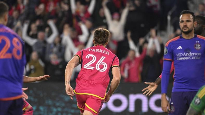 Feb 20, 2024; St. Louis, MO, USA; St. Louis City defender Tim Parker (26) reacts after scoring a goal against the Houston Dynamo during the second half of the CONCACAF Champions Cup-Round One at CITYPARK. Mandatory Credit: Joe Puetz-USA TODAY Sports