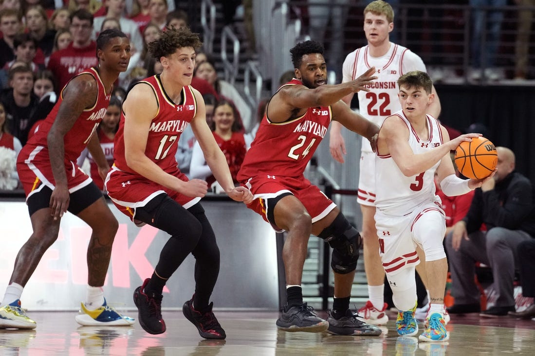 Feb 20, 2024; Madison, Wisconsin, USA;  Wisconsin Badgers guard Connor Essegian (3) passes the ball against Maryland Terrapins forward Donta Scott (24) and Maryland Terrapins forward Jamie Kaiser Jr. (12) during the first half at the Kohl Center. Mandatory Credit: Kayla Wolf-USA TODAY Sports