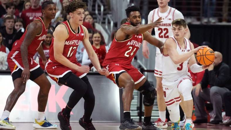 Feb 20, 2024; Madison, Wisconsin, USA;  Wisconsin Badgers guard Connor Essegian (3) passes the ball against Maryland Terrapins forward Donta Scott (24) and Maryland Terrapins forward Jamie Kaiser Jr. (12) during the first half at the Kohl Center. Mandatory Credit: Kayla Wolf-USA TODAY Sports