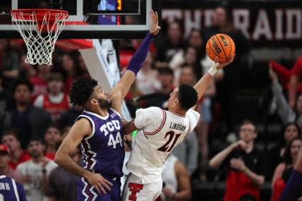 Feb 20, 2024; Lubbock, Texas, USA;  Texas Tech Red Raiders forward KyeRon Lindsey (21) shoots against TCU Horned Frogs forward Essam Mostafa (44) in the first half at United Supermarkets Arena. Mandatory Credit: Michael C. Johnson-USA TODAY Sports