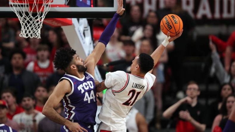 Feb 20, 2024; Lubbock, Texas, USA;  Texas Tech Red Raiders forward KyeRon Lindsey (21) shoots against TCU Horned Frogs forward Essam Mostafa (44) in the first half at United Supermarkets Arena. Mandatory Credit: Michael C. Johnson-USA TODAY Sports