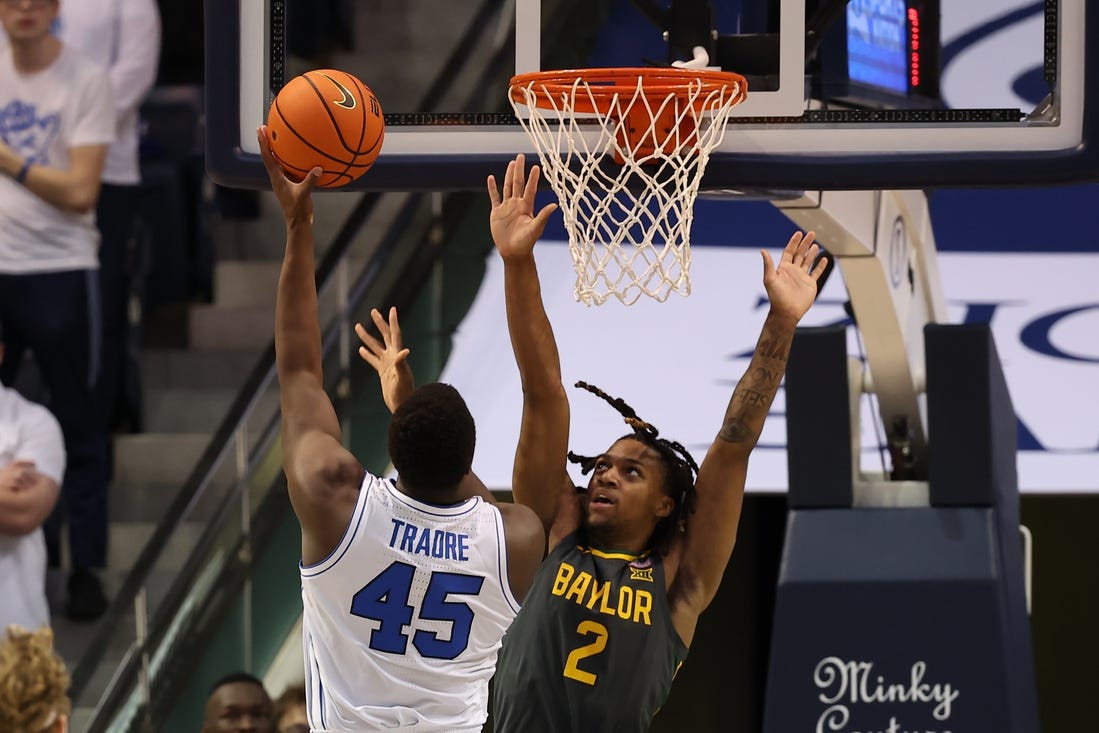 Feb 20, 2024; Provo, Utah, USA; Brigham Young Cougars forward Fousseyni Traore (45) shoots over Baylor Bears guard Jayden Nunn (2) during the second half at Marriott Center. Mandatory Credit: Rob Gray-USA TODAY Sports