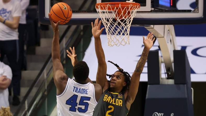 Feb 20, 2024; Provo, Utah, USA; Brigham Young Cougars forward Fousseyni Traore (45) shoots over Baylor Bears guard Jayden Nunn (2) during the second half at Marriott Center. Mandatory Credit: Rob Gray-USA TODAY Sports