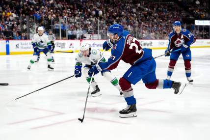 Feb 20, 2024; Denver, Colorado, USA; Colorado Avalanche left wing Jonathan Drouin (27) shoots the puck in the second period against the Vancouver Canucks at Ball Arena. Mandatory Credit: Ron Chenoy-USA TODAY Sports