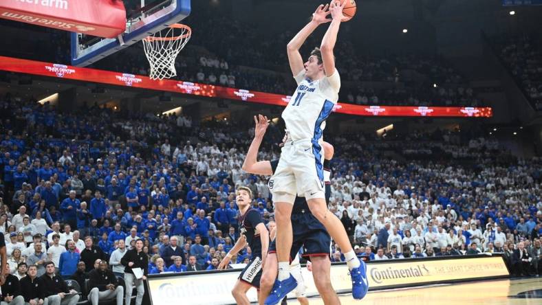 Feb 20, 2024; Omaha, Nebraska, USA; Creighton Bluejays center Ryan Kalkbrenner (11) grabs a pass against the Connecticut Huskies in the second half at CHI Health Center Omaha. Mandatory Credit: Steven Branscombe-USA TODAY Sports