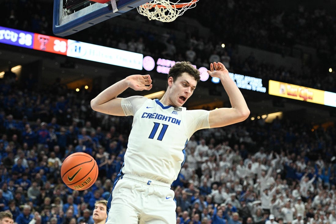 Feb 20, 2024; Omaha, Nebraska, USA; Creighton Bluejays center Ryan Kalkbrenner (11) dunks against the Connecticut Huskies in the second half at CHI Health Center Omaha. Mandatory Credit: Steven Branscombe-USA TODAY Sports