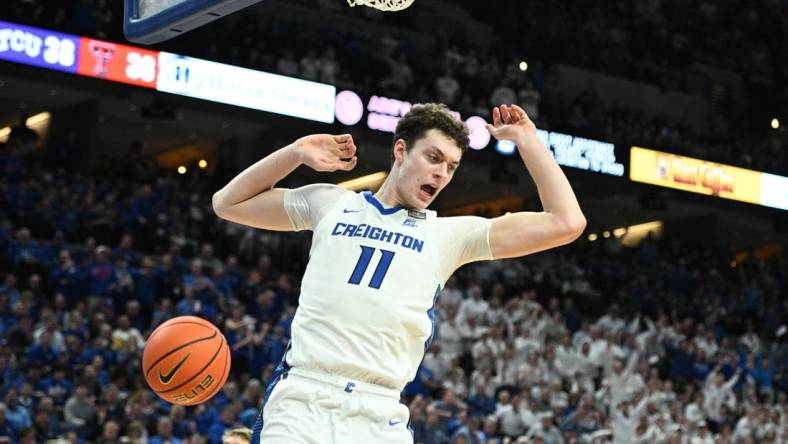 Feb 20, 2024; Omaha, Nebraska, USA; Creighton Bluejays center Ryan Kalkbrenner (11) dunks against the Connecticut Huskies in the second half at CHI Health Center Omaha. Mandatory Credit: Steven Branscombe-USA TODAY Sports