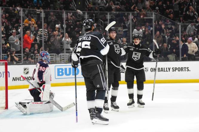 Feb 20, 2024; Los Angeles, California, USA; LA Kings center Pierre-Luc Dubois (80) celebrates after scoring a goal with right wing Quinton Byfield (55) and center Alex Turcotte (38) as Columbus Blue Jackets goaltender Elvis Merzlikins (90) reacts  in the second period at Crypto.com Arena. Mandatory Credit: Kirby Lee-USA TODAY Sports