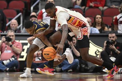 Feb 21, 2024; Louisville, Kentucky, USA; Notre Dame Fighting Irish guard Markus Burton (3) scrambles for a loose ball with Louisville Cardinals forward Brandon Huntley-Hatfield (5) during the first half at KFC Yum! Center. Mandatory Credit: Jamie Rhodes-USA TODAY Sports