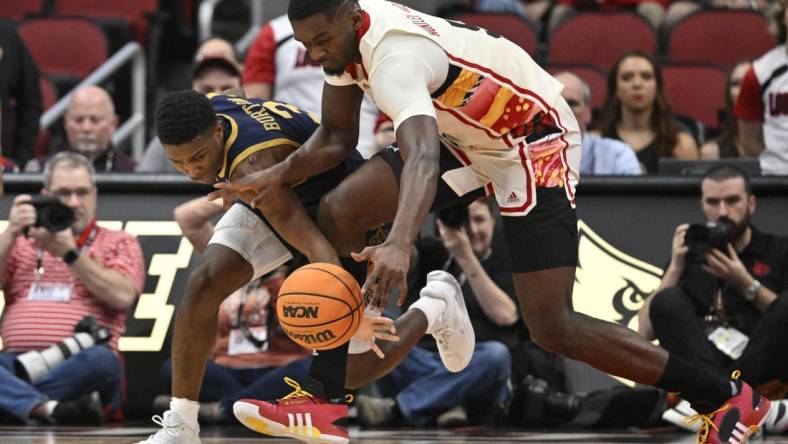 Feb 21, 2024; Louisville, Kentucky, USA; Notre Dame Fighting Irish guard Markus Burton (3) scrambles for a loose ball with Louisville Cardinals forward Brandon Huntley-Hatfield (5) during the first half at KFC Yum! Center. Mandatory Credit: Jamie Rhodes-USA TODAY Sports