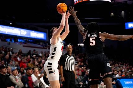 Cincinnati Bearcats guard Simas Lukosius (41) hits a basket over Oklahoma State Cowboys guard Quion Williams (5) in the first half of the NCAA basketball game between Cincinnati Bearcats and Oklahoma State Cowboys at Fifth Third Arena in Cincinnati on Wednesday, Feb. 21, 2024.