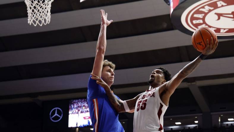 Feb 21, 2024; Tuscaloosa, Alabama, USA; Alabama Crimson Tide guard Aaron Estrada (55) shoots as Florida Gators center Micah Handlogten (3) defends during the first half at Coleman Coliseum. Mandatory Credit: Butch Dill-USA TODAY Sports