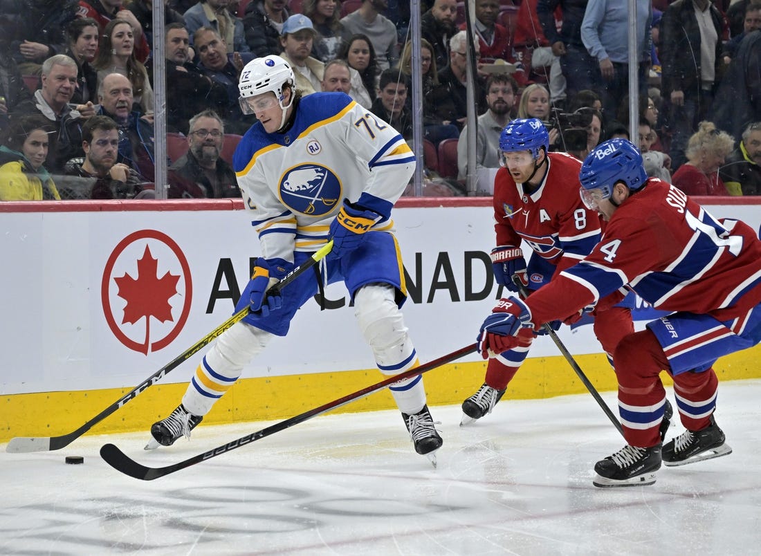 Feb 21, 2024; Montreal, Quebec, CAN; Buffalo Sabres forward Tage Thompson (72) plays the puck and Montreal Canadiens forward Nick Suzuki (14) defends during the second period at the Bell Centre. Mandatory Credit: Eric Bolte-USA TODAY Sports