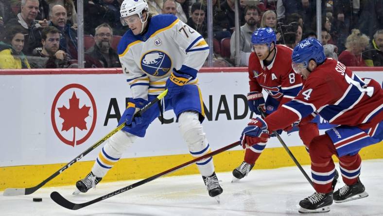 Feb 21, 2024; Montreal, Quebec, CAN; Buffalo Sabres forward Tage Thompson (72) plays the puck and Montreal Canadiens forward Nick Suzuki (14) defends during the second period at the Bell Centre. Mandatory Credit: Eric Bolte-USA TODAY Sports