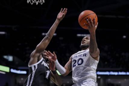 Feb 21, 2024; Cincinnati, Ohio, USA; Xavier Musketeers guard Dayvion McKnight (20) shoots against Providence Friars guard Jayden Pierre (1) in the first half at Cintas Center. Mandatory Credit: Katie Stratman-USA TODAY Sports