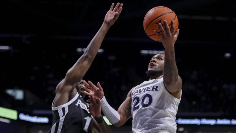 Feb 21, 2024; Cincinnati, Ohio, USA; Xavier Musketeers guard Dayvion McKnight (20) shoots against Providence Friars guard Jayden Pierre (1) in the first half at Cintas Center. Mandatory Credit: Katie Stratman-USA TODAY Sports