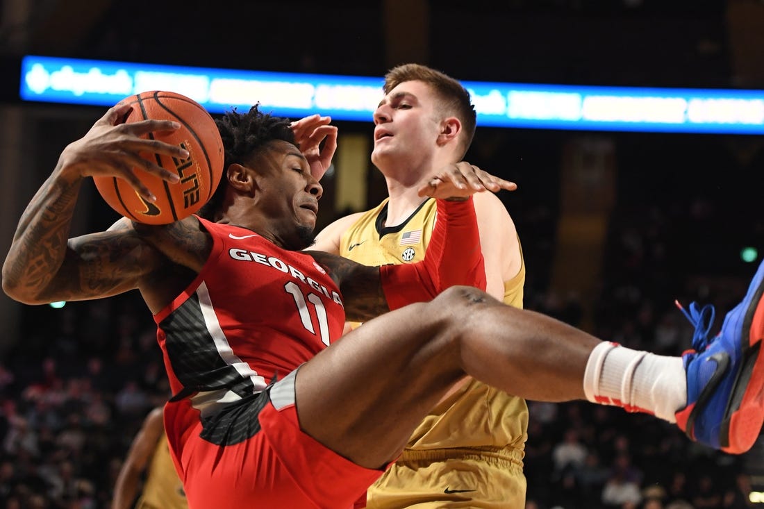 Feb 21, 2024; Nashville, Tennessee, USA; Georgia Bulldogs guard Justin Hill (11) grabs a rebound against Vanderbilt Commodores forward Carter Lang (35) during the first half at Memorial Gymnasium. Mandatory Credit: Christopher Hanewinckel-USA TODAY Sports