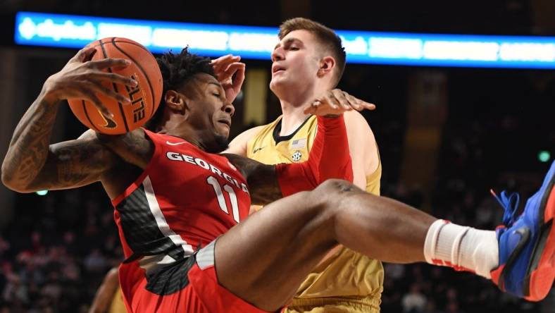 Feb 21, 2024; Nashville, Tennessee, USA; Georgia Bulldogs guard Justin Hill (11) grabs a rebound against Vanderbilt Commodores forward Carter Lang (35) during the first half at Memorial Gymnasium. Mandatory Credit: Christopher Hanewinckel-USA TODAY Sports