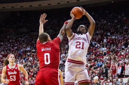 Feb 21, 2024; Bloomington, Indiana, USA; Indiana Hoosiers forward Mackenzie Mgbako (21) shoots the ball while Nebraska Cornhuskers guard C.J. Wilcher (0) defends in the first half at Simon Skjodt Assembly Hall. Mandatory Credit: Trevor Ruszkowski-USA TODAY Sports