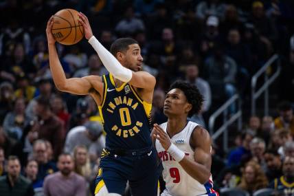 Feb 22, 2024; Indianapolis, Indiana, USA; Indiana Pacers guard Tyrese Haliburton (0) holds the ball while Detroit Pistons forward Ausar Thompson (9) defends in the first half at Gainbridge Fieldhouse. Mandatory Credit: Trevor Ruszkowski-USA TODAY Sports