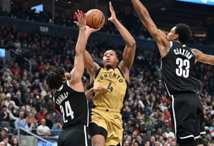 Feb 22, 2024; Toronto, Ontario, CAN;   Toronto Raptors forward Scottie Barnes (4) shoots the ball as Brooklyn Nets guard Cam Thomas (24) and center Nic Claxton (33) defend in the first half at Scotiabank Arena. Mandatory Credit: Dan Hamilton-USA TODAY Sports