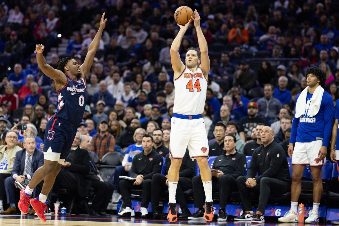 Feb 22, 2024; Philadelphia, Pennsylvania, USA; New York Knicks forward Bojan Bogdanovic (44) scores a three pointer in front of Philadelphia 76ers guard Tyrese Maxey (0) during the second quarter at Wells Fargo Center. Mandatory Credit: Bill Streicher-USA TODAY Sports