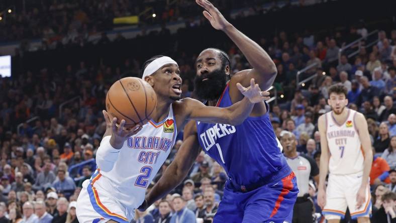 Feb 22, 2024; Oklahoma City, Oklahoma, USA; Oklahoma City Thunder guard Shai Gilgeous-Alexander (2) moves to the basket beside LA Clippers guard James Harden (1) during the second quarter at Paycom Center. Mandatory Credit: Alonzo Adams-USA TODAY Sports