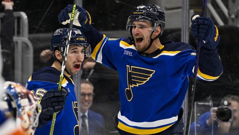 Feb 22, 2024; St. Louis, Missouri, USA;  St. Louis Blues left wing Pavel Buchnevich (89) celebrates with center Jordan Kyrou (25) after scoring his second goal of the game against New York Islanders goaltender Semyon Varlamov (40) during the second period at Enterprise Center. Mandatory Credit: Jeff Curry-USA TODAY Sports