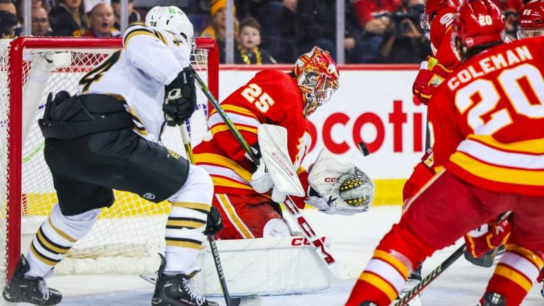 Feb 22, 2024; Calgary, Alberta, CAN; Calgary Flames goaltender Jacob Markstrom (25) makes a save against the Boston Bruins during the first period at Scotiabank Saddledome. Mandatory Credit: Sergei Belski-USA TODAY Sports