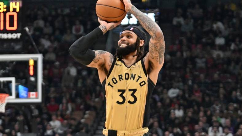 Feb 22, 2024; Toronto, Ontario, CAN;  Toronto Raptors guard Gary Trent Jr. (33) shoots the ball against the Brooklyn Nets in the first half at Scotiabank Arena. Mandatory Credit: Dan Hamilton-USA TODAY Sports