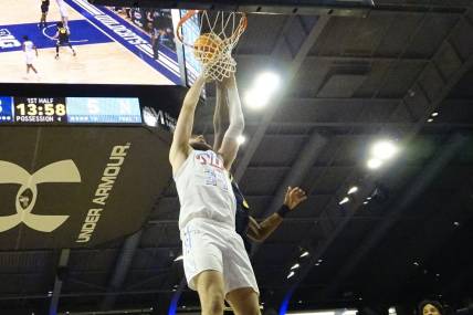 Feb 22, 2024; Evanston, Illinois, USA; Northwestern Wildcats center Matthew Nicholson (34) scores against the Michigan Wolverines  during the first half at Welsh-Ryan Arena. Mandatory Credit: David Banks-USA TODAY Sports