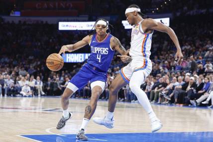 Feb 22, 2024; Oklahoma City, Oklahoma, USA; Oklahoma City Thunder guard Shai Gilgeous-Alexander (2) defends a drive by LA Clippers guard Brandon Boston Jr. (4) during the second half at Paycom Center. Mandatory Credit: Alonzo Adams-USA TODAY Sports