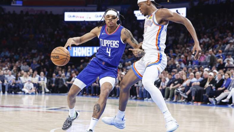 Feb 22, 2024; Oklahoma City, Oklahoma, USA; Oklahoma City Thunder guard Shai Gilgeous-Alexander (2) defends a drive by LA Clippers guard Brandon Boston Jr. (4) during the second half at Paycom Center. Mandatory Credit: Alonzo Adams-USA TODAY Sports