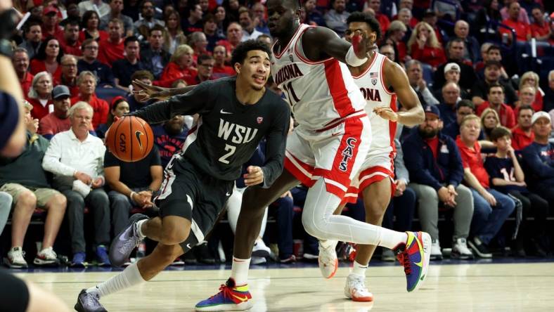 Feb 22, 2024; Tucson, Arizona, USA; Washington State Cougars guard Myles Rice (2) drives to the net against Arizona Wildcats center Oumar Ballo (11) during the first half at McKale Center. Mandatory Credit: Zachary BonDurant-USA TODAY Sports